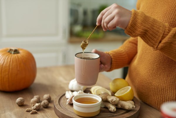 woman making hot tea with honey.jpg